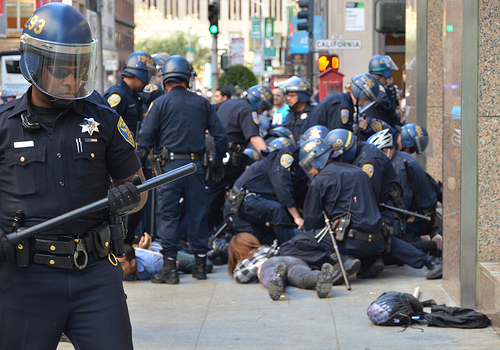 SF riot cops arresting protesters during anti-colonial march, Oct 2012.